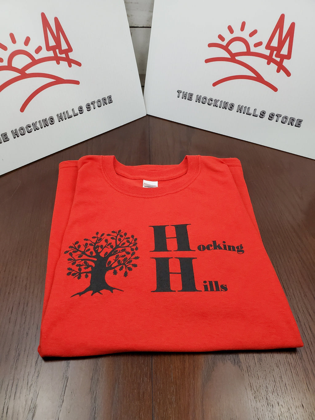 The Hocking Hills Store red cotton t-shirt with black Hocking Hills logo and oak tree graphic.