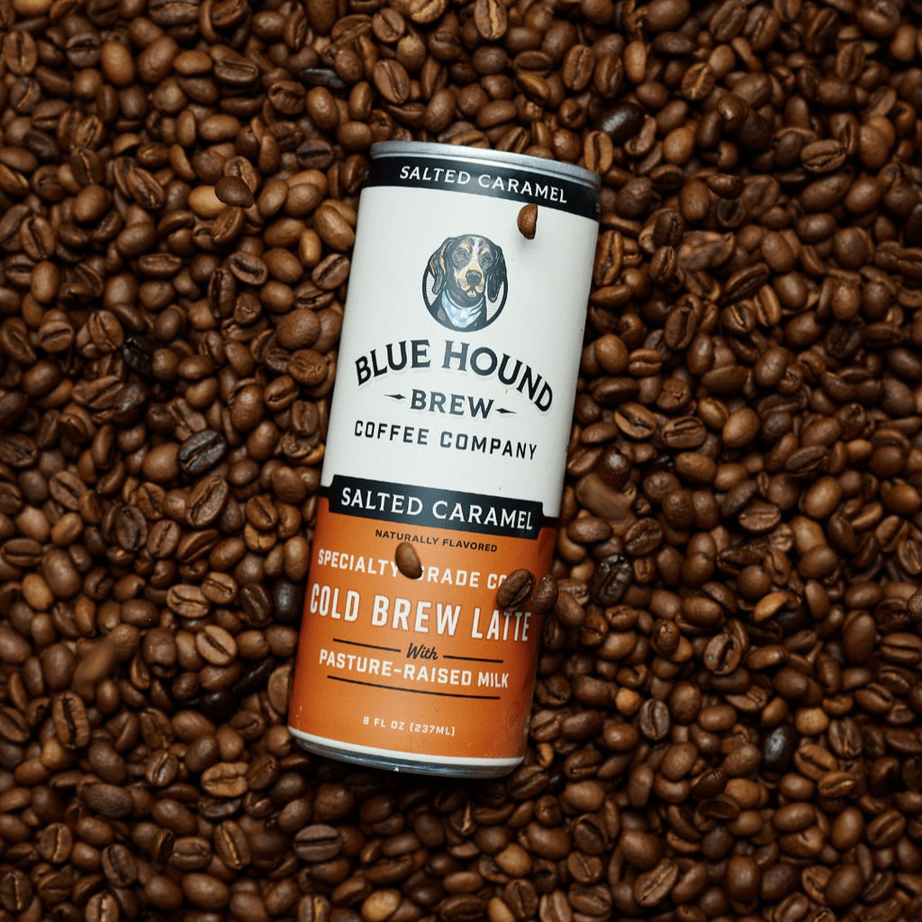 The Hocking Hills Store Salted Caramel Cold Brew Latte can surrounded by coffee beans.