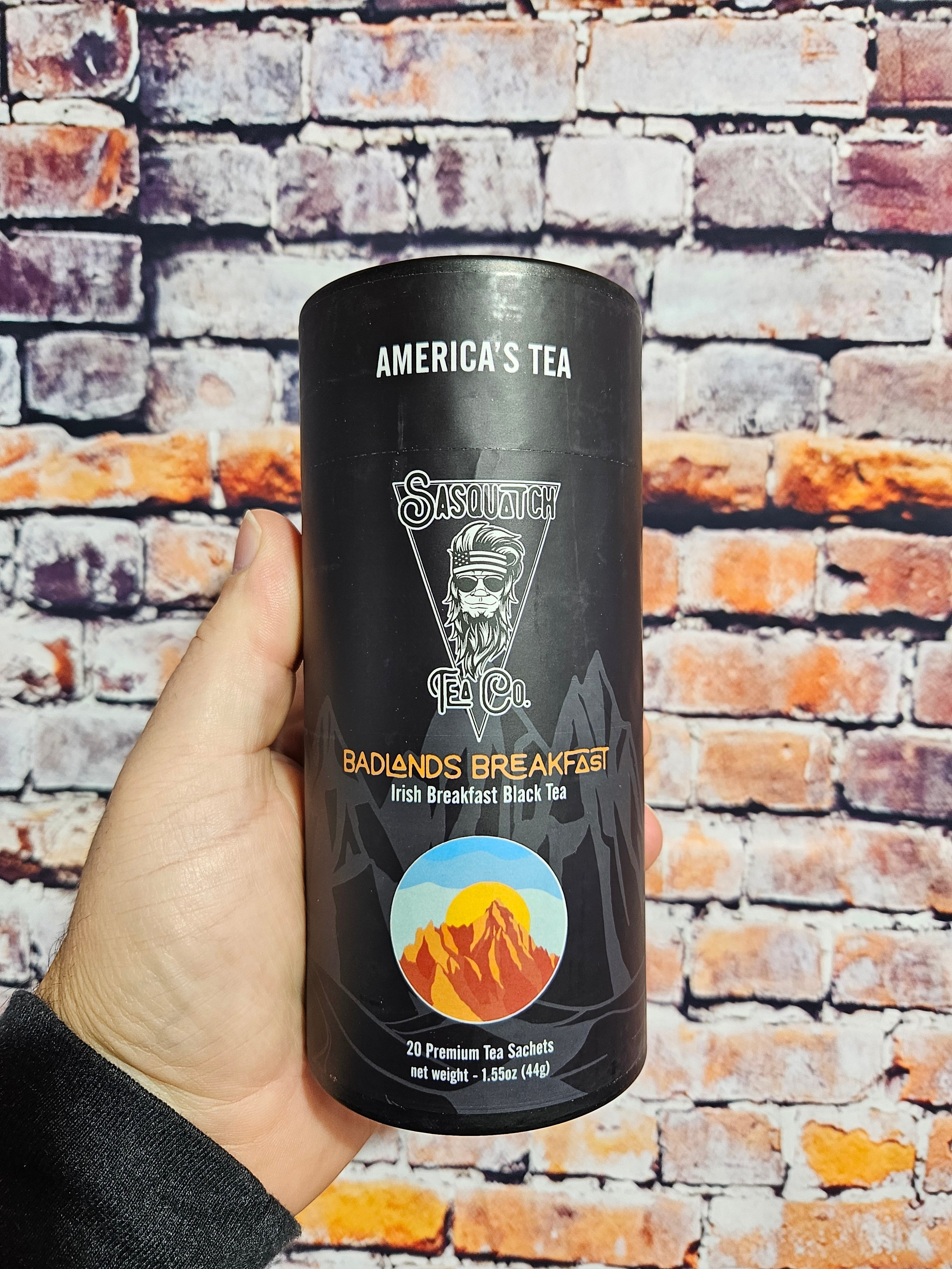 The Hocking Hills Store Sasquatch Tea Co. Badlands Breakfast Irish Breakfast Black Tea in a black cylinder with a mountain sunset graphic. Contains 20 premium tea sachets.