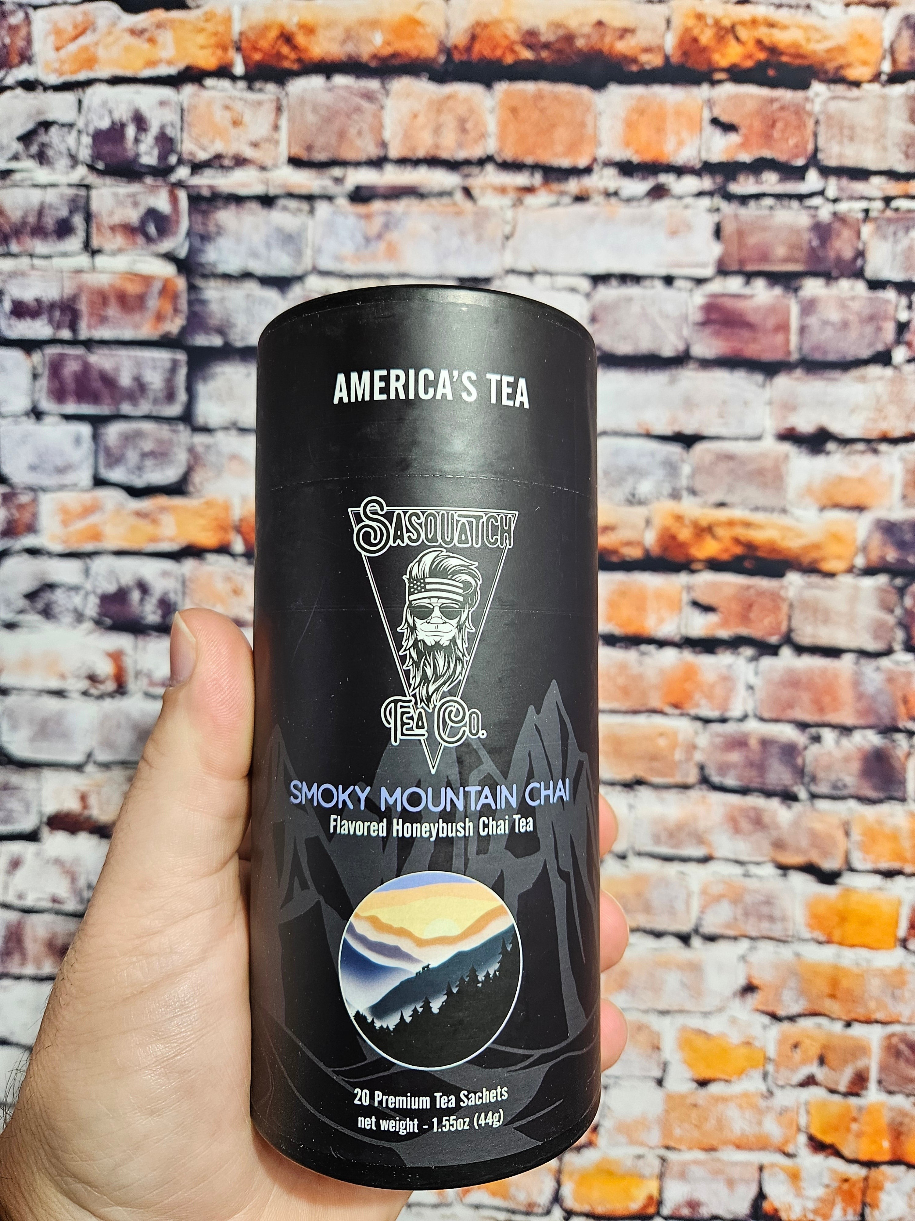 The Hocking Hills Store Sasquatch Tea Co. Smoky Mountain Chai flavored honeybush tea in a black cylindrical container with mountain imagery.