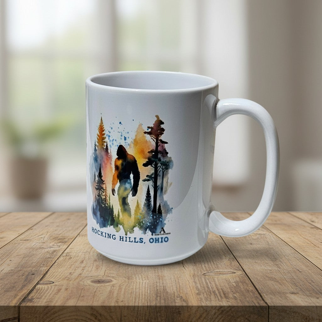 The Hocking Hills Store Sasquatch Big Foot watercolor ceramic coffee mug with forest scene.