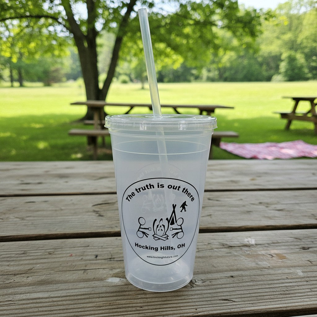 The Hocking Hills Store clear plastic sipper cup with lid and straw, featuring a Bigfoot and campfire graphic.