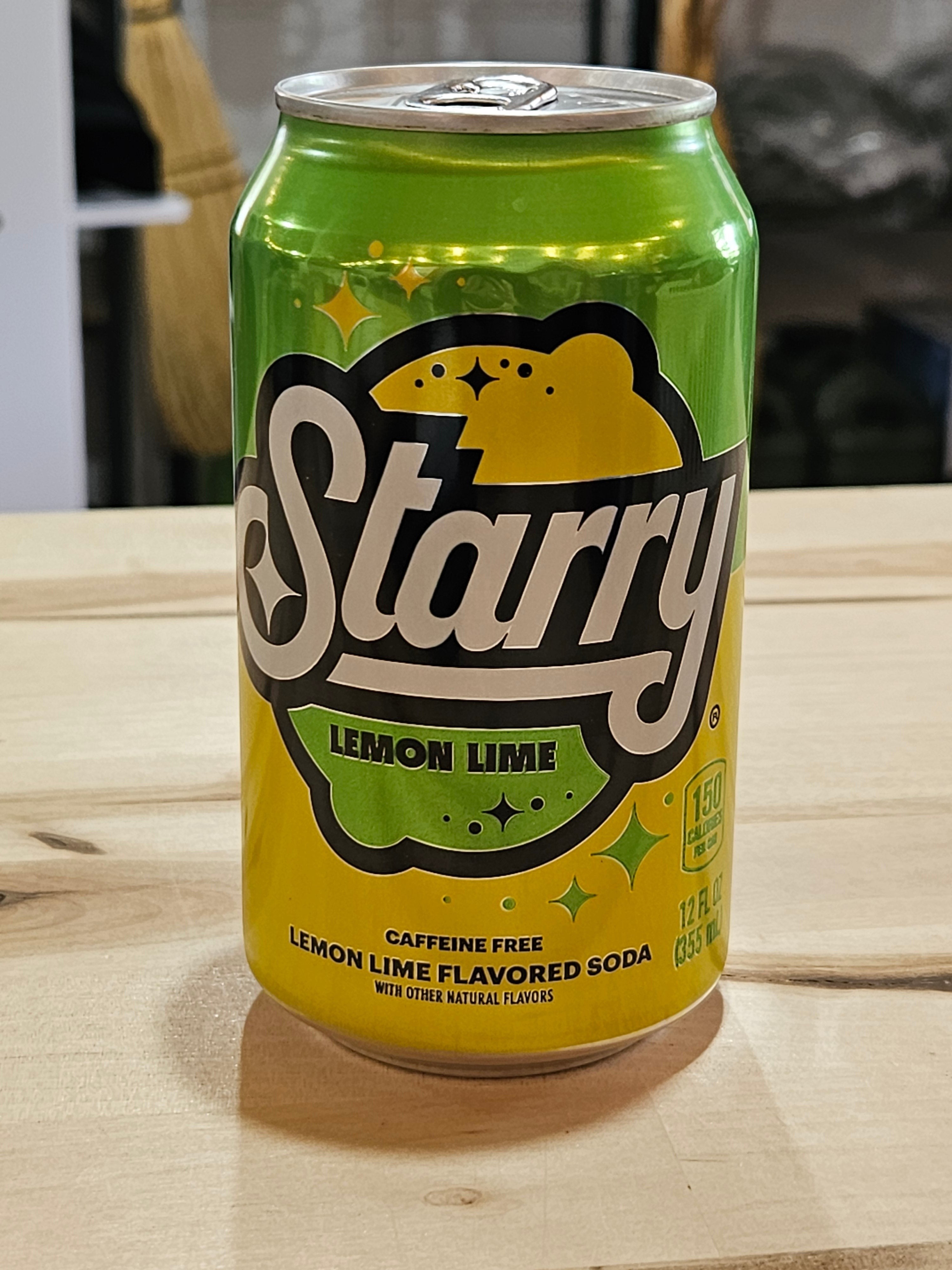 The Hocking Hills Store Starry lemon lime soda can with green and yellow branding on a wooden surface.