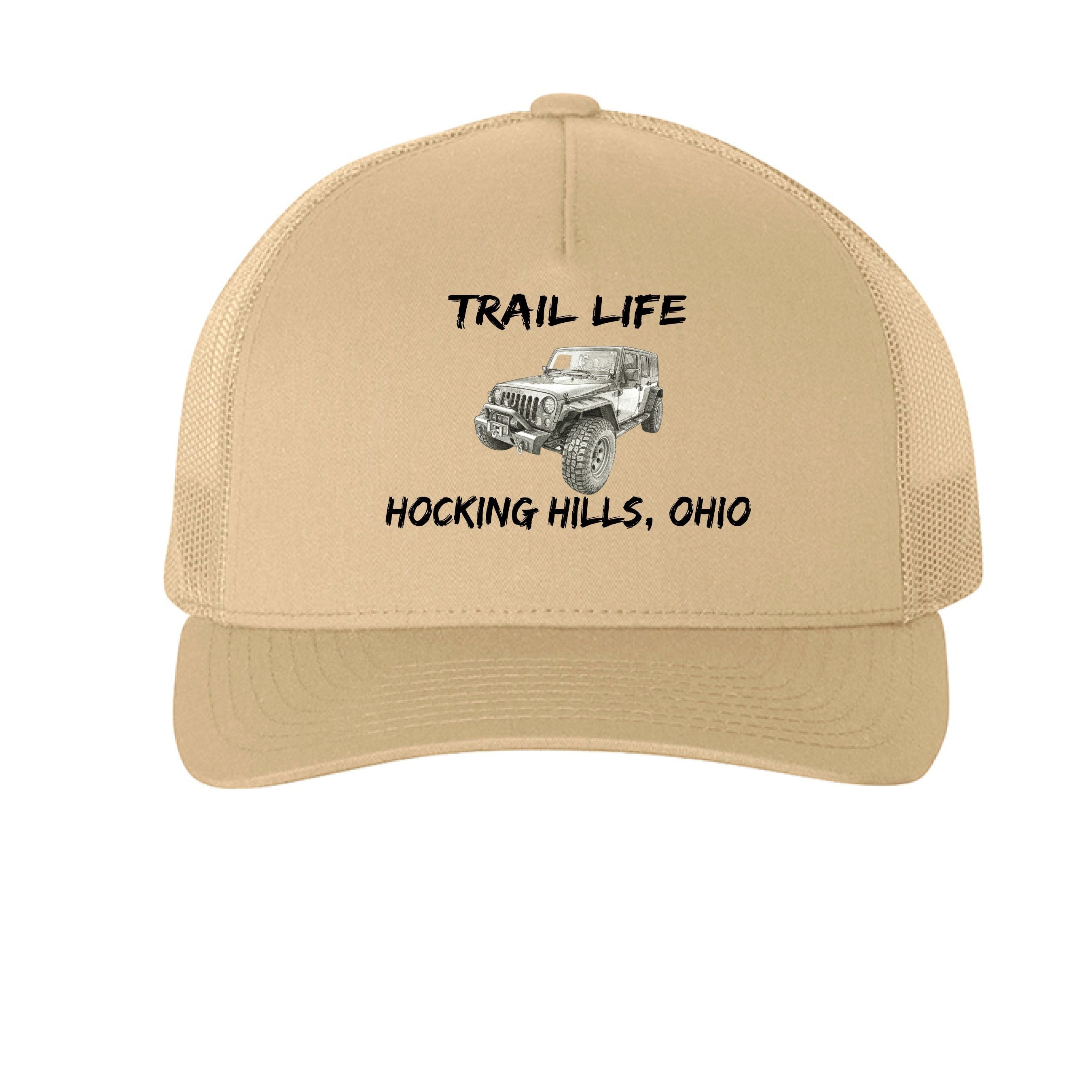 The Hocking Hills Store Trail Life Jeep Hat is a tan, five-panel trucker cap with a mesh back and snapback closure. Features a graphic of a Jeep and text.