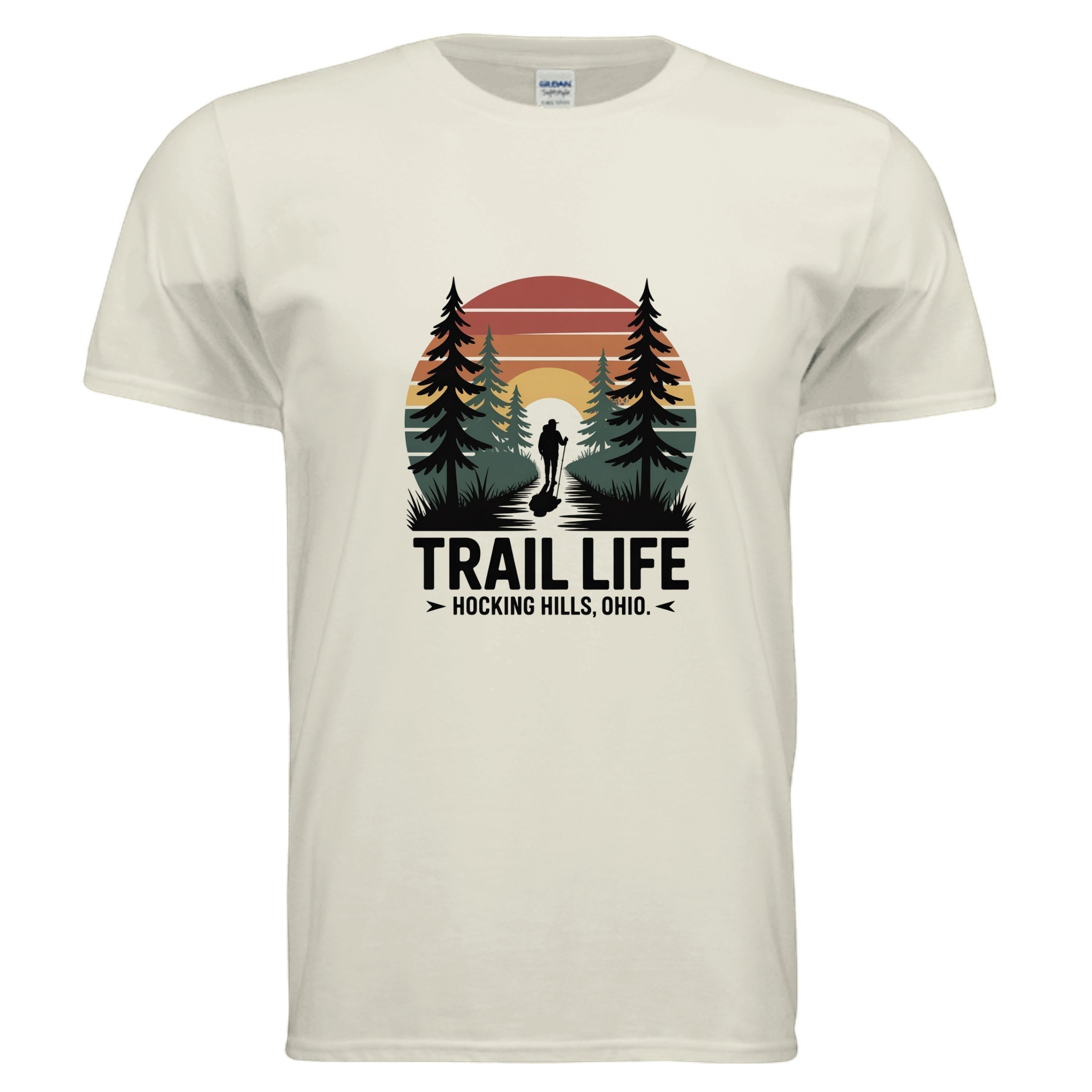 The Hocking Hills Store cream t-shirt with a vintage sunset graphic featuring a hiker on a trail between pine trees. Text reads "TRAIL LIFE HOCKING HILLS, OHIO."