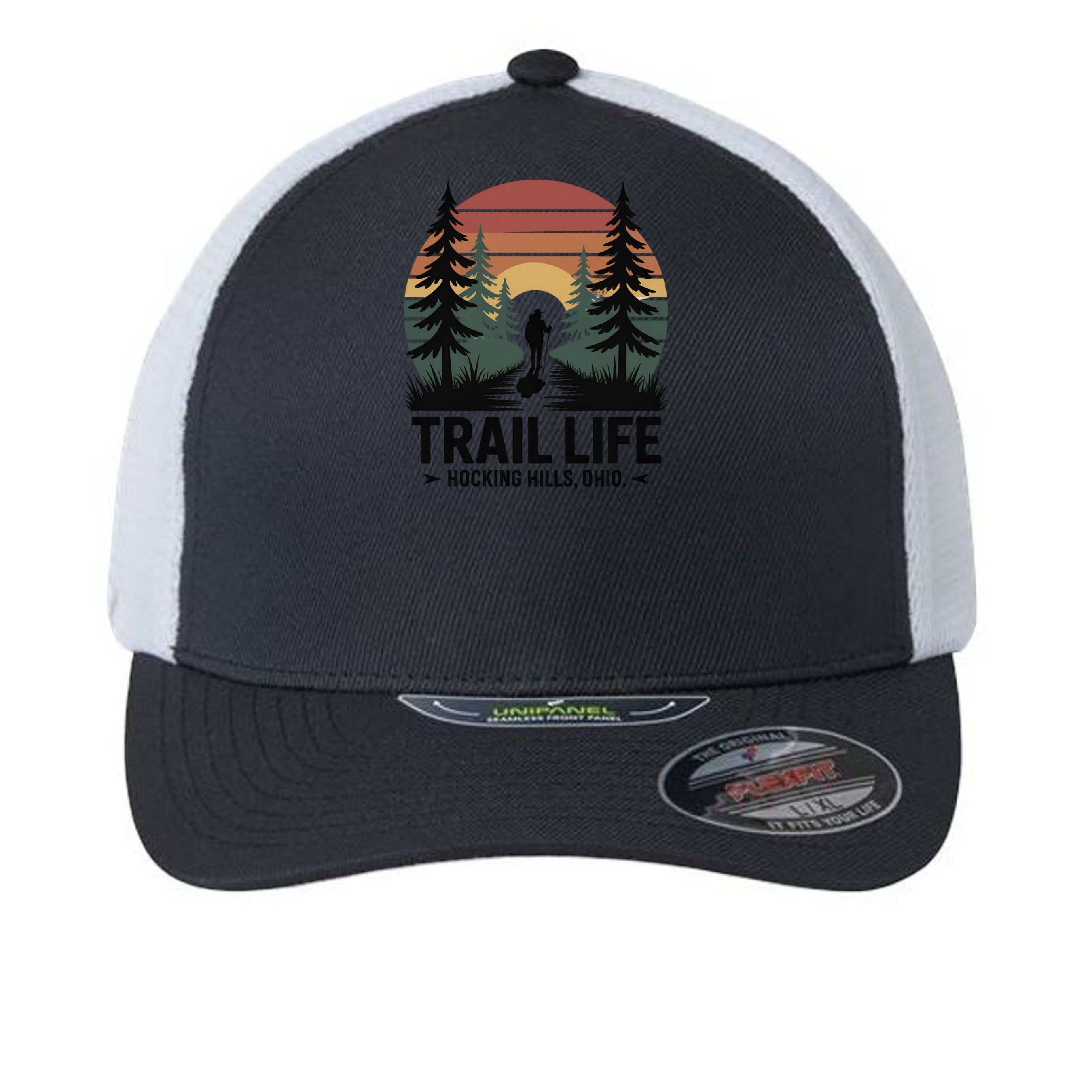 The Hocking Hills Store fitted trucker hat with a "Trail Life" graphic featuring a hiker, trees, and sunset. Dark grey front, white mesh back.