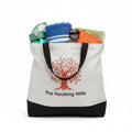 The Hocking Hills Store large two-tone cloth tote bag with black handles and base, featuring an orange oak tree graphic and text.