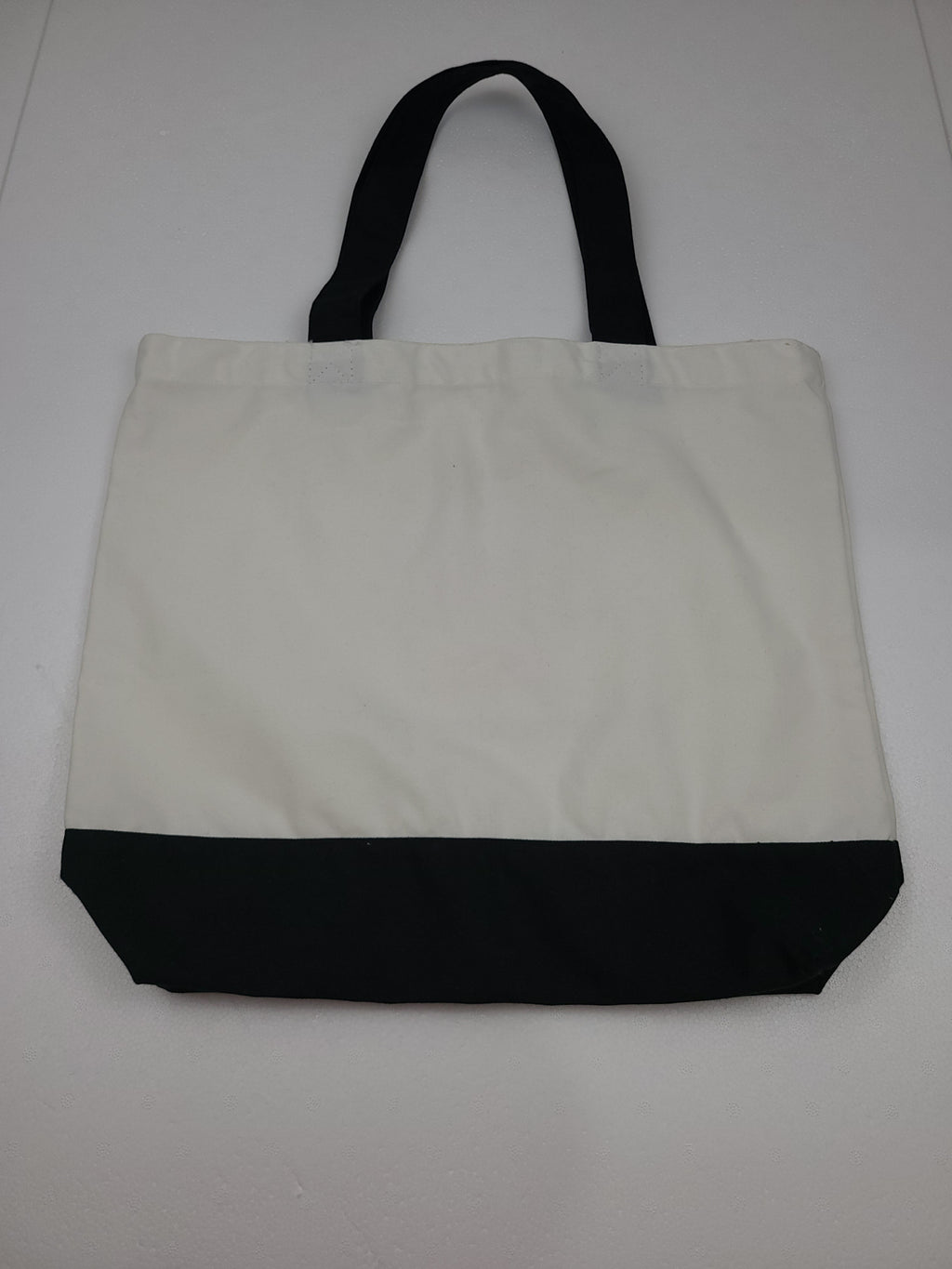 The Hocking Hills Store large two-tone cloth tote bag in white and black with black handles.