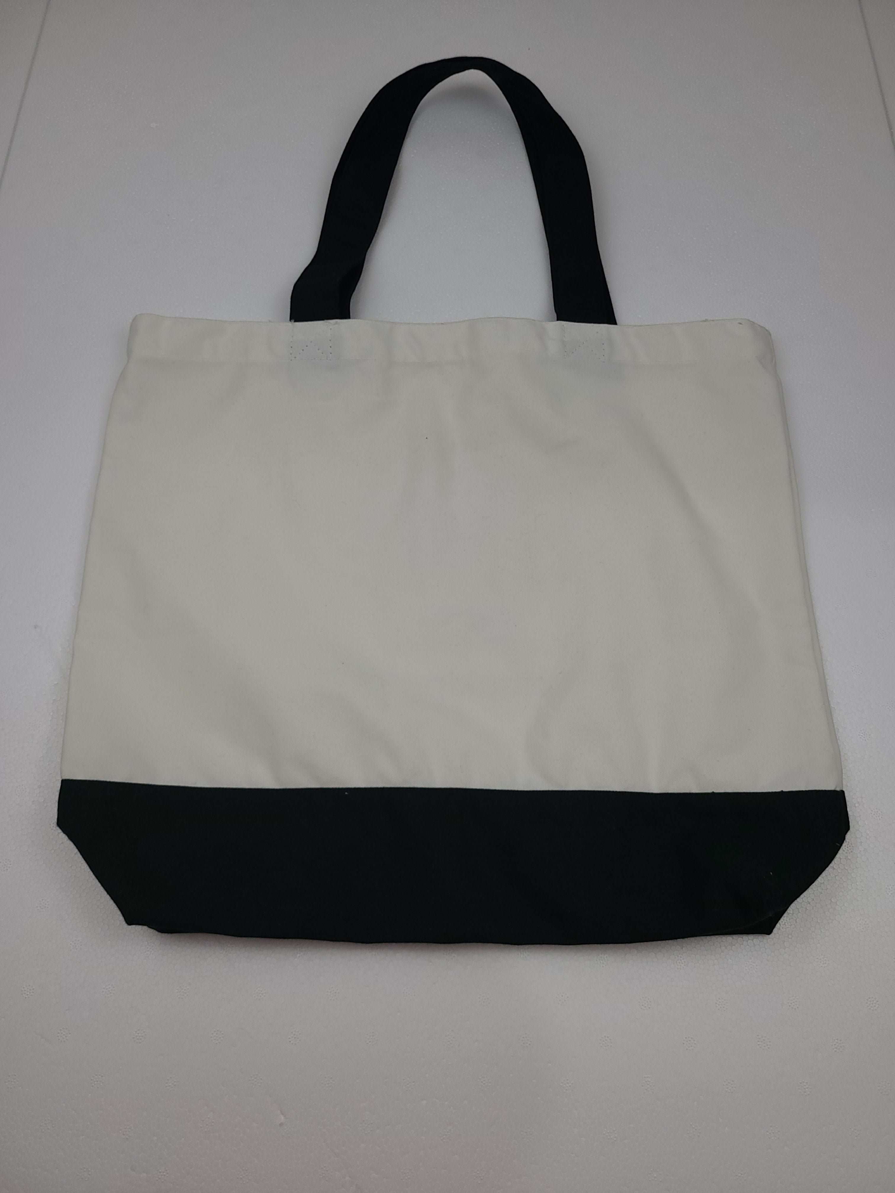 The Hocking Hills Store large two-tone cloth tote bag in white and black with black handles.