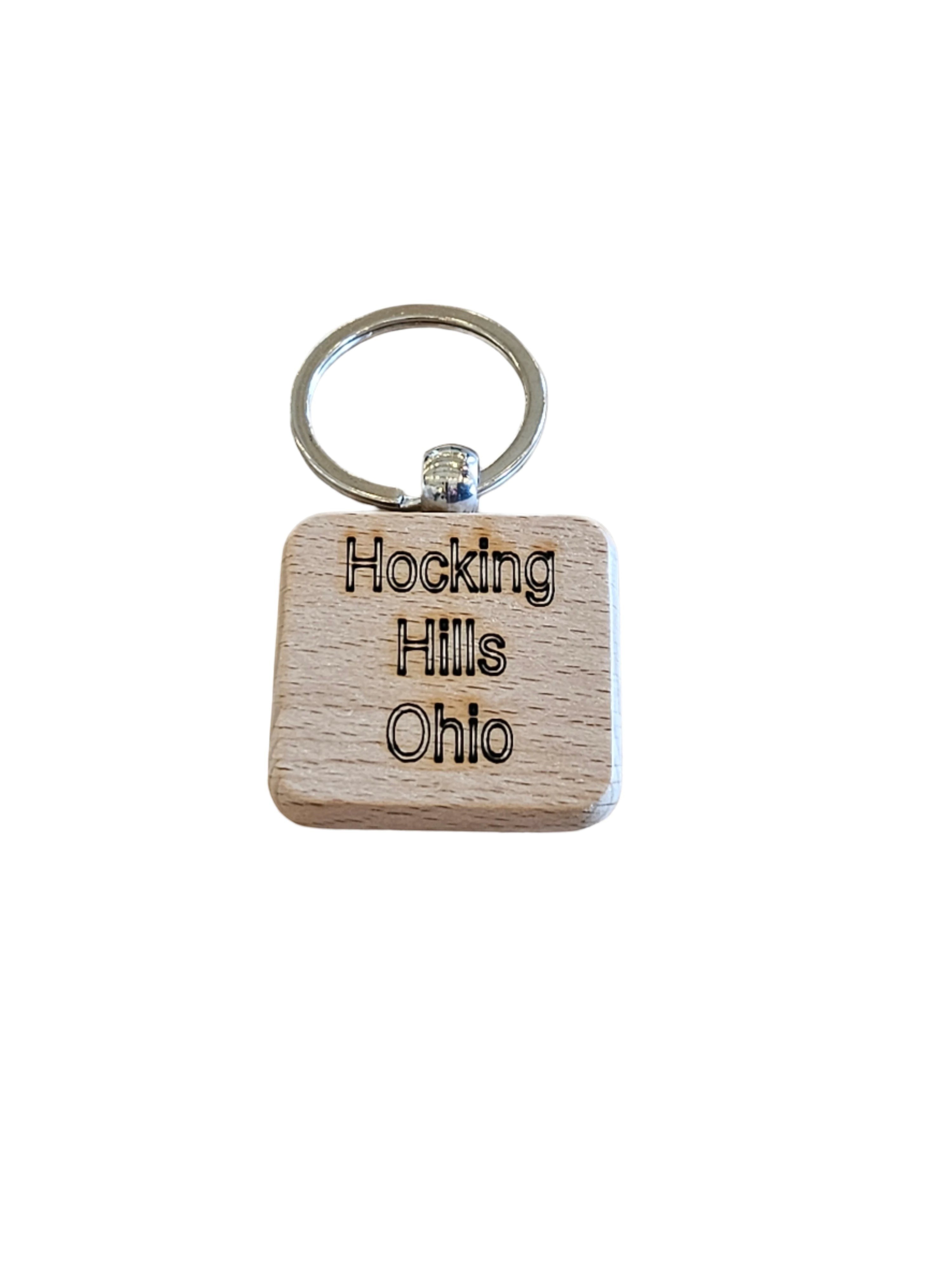The Hocking Hills Store wood engraved keychain with "Hocking Hills Ohio" text. Square wooden charm with silver keyring.