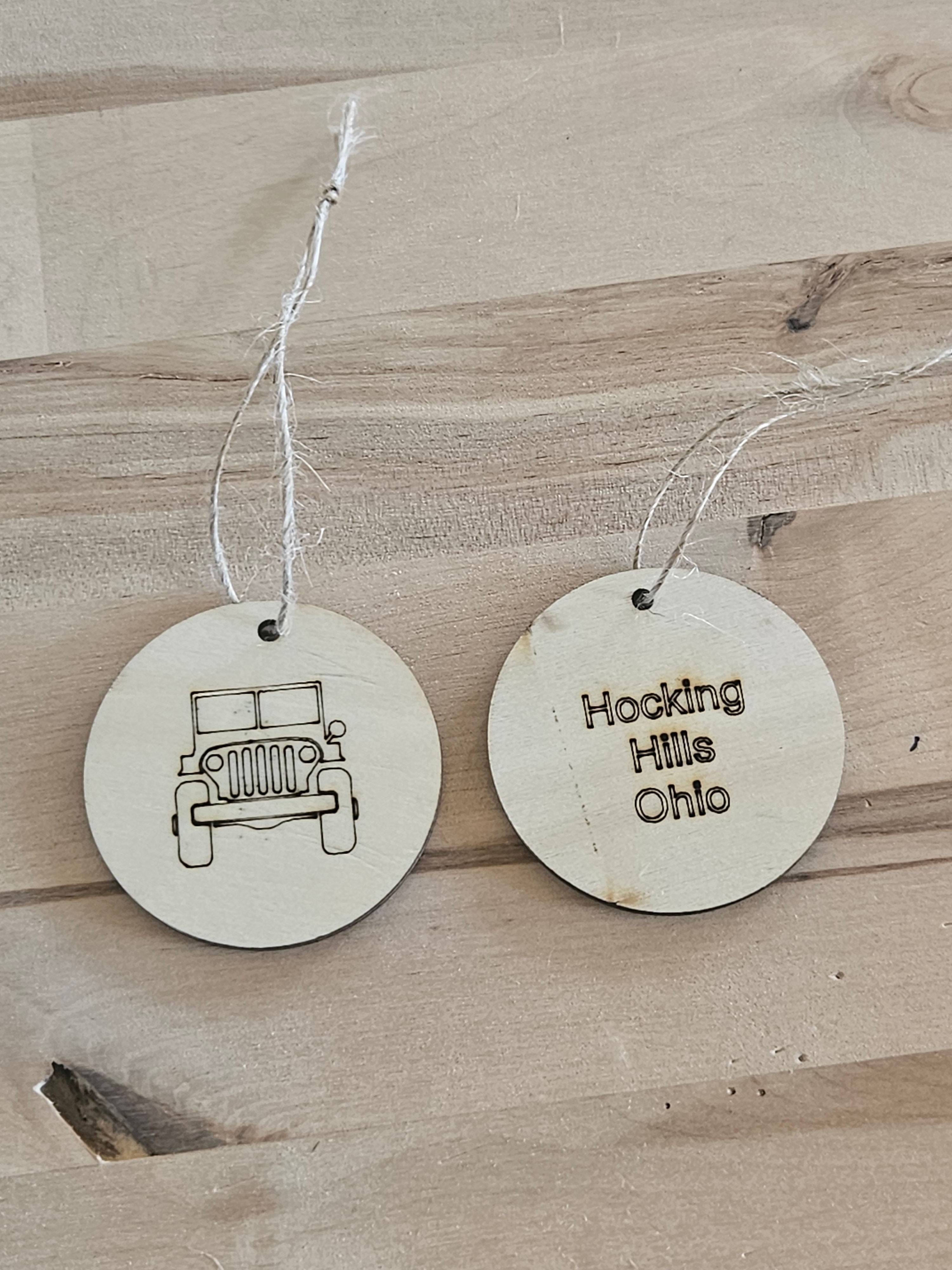 The Hocking Hills Store wood engraved collectable Christmas ornament featuring a jeep on one side and Hocking Hills Ohio engraved on the other.