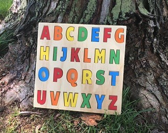 The Hocking Hills Store handmade wooden alphabet puzzle with colourful letters on a natural wood board, perfect for early learning.