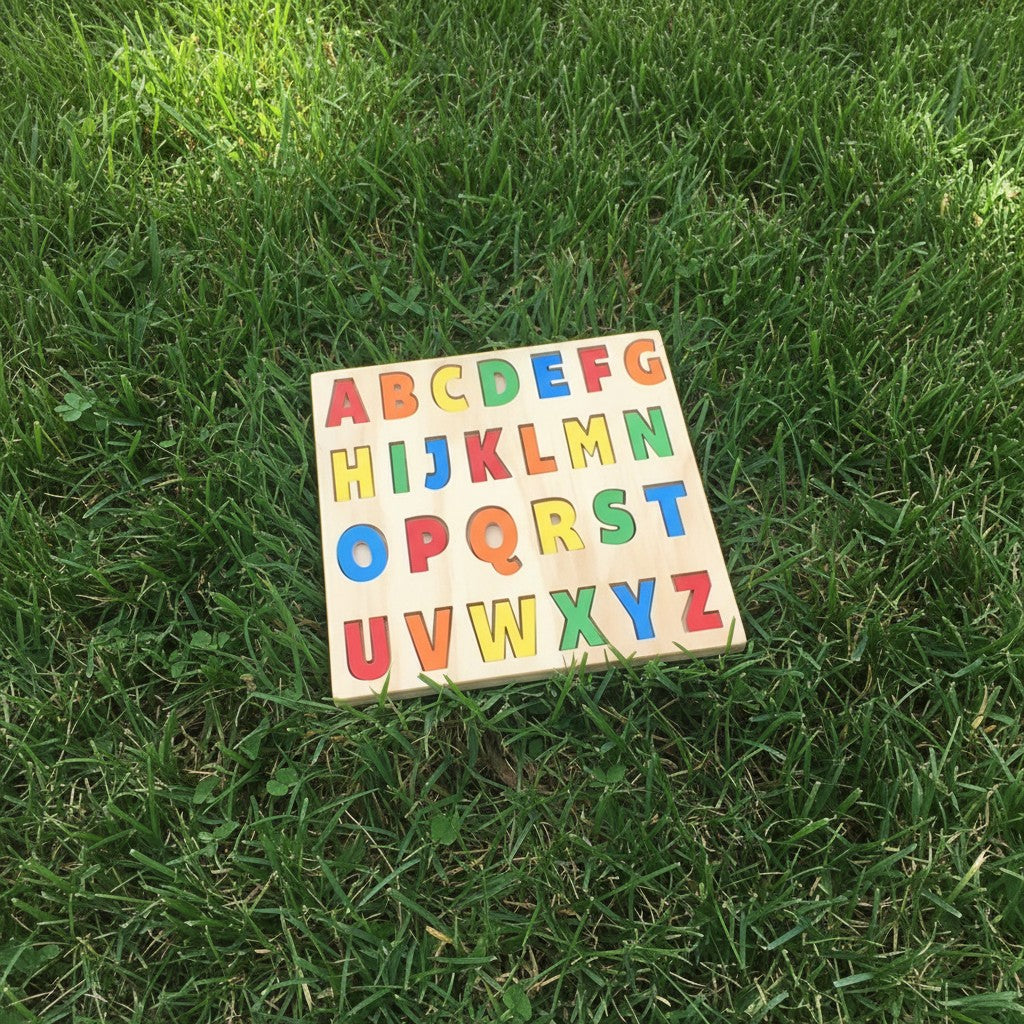 The Hocking Hills Store handmade wooden alphabet puzzle with colorful letters on a natural wood board. Educational toy for children.