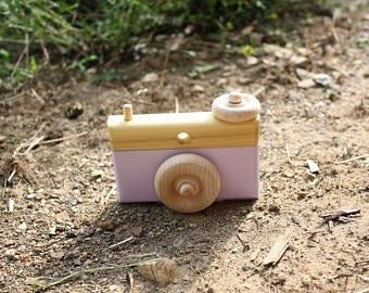The Hocking Hills Store handmade wooden toy camera for kids, natural wood with a lilac front, sparks imagination.