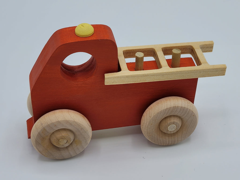 The Hocking Hills Store handmade red wooden toy fire truck with natural wood wheels and ladder.