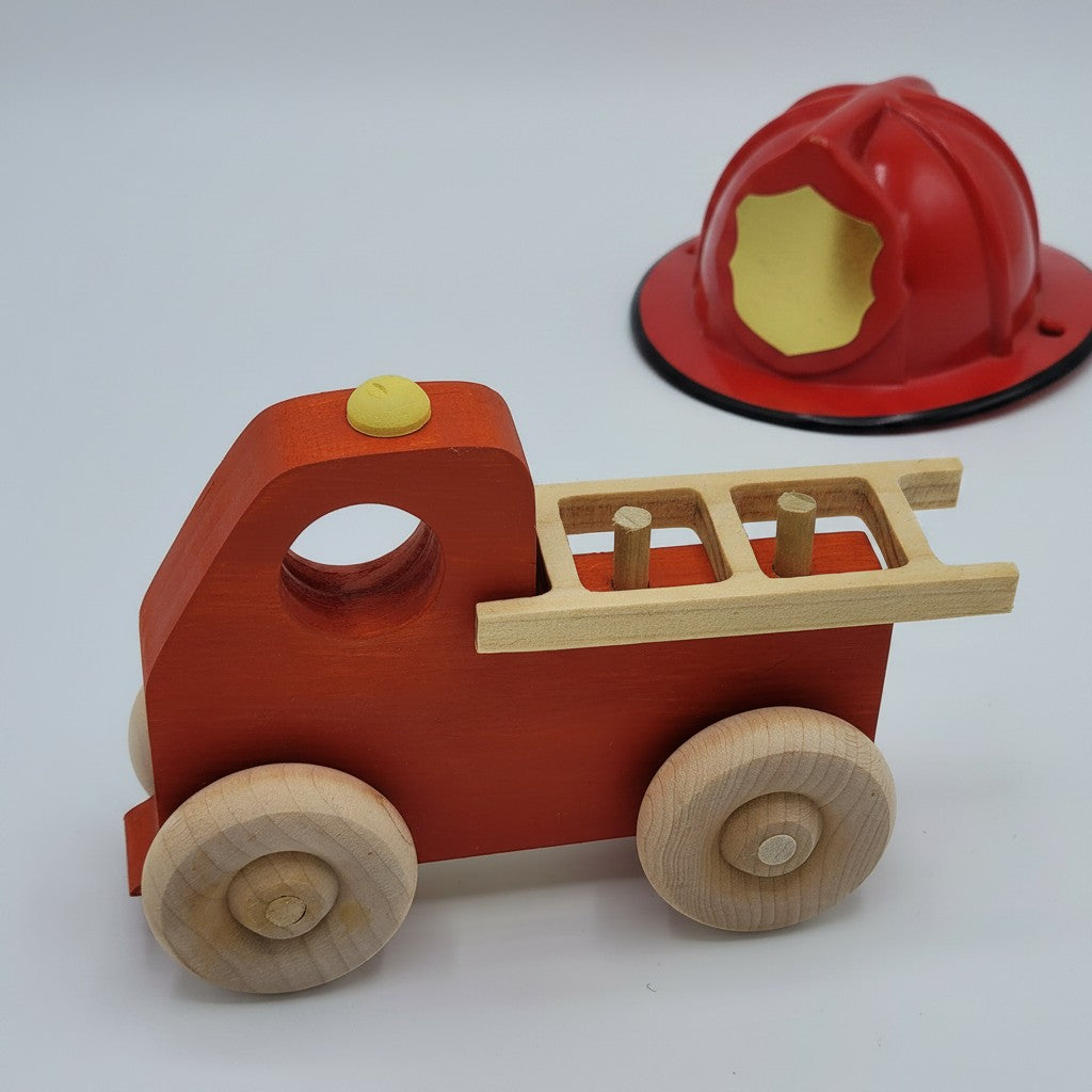 The Hocking Hills Store handmade red wooden toy fire truck with natural wood wheels and ladder detail.