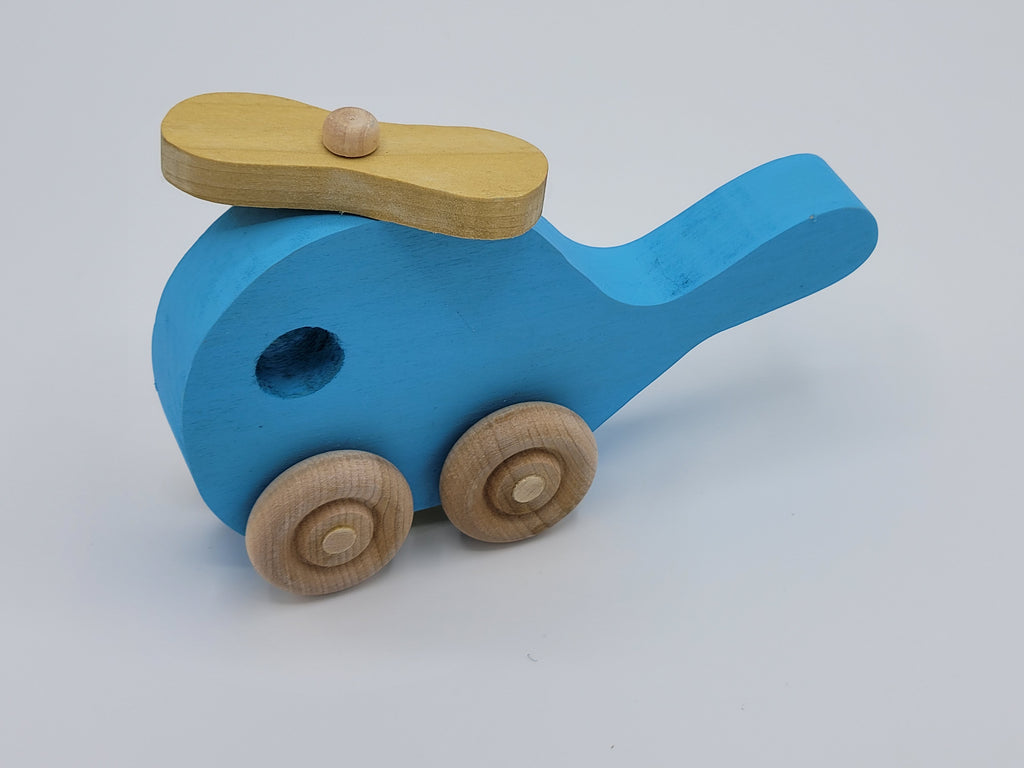 The Hocking Hills Store handmade blue wooden toy helicopter with yellow rotor and natural wood wheels.