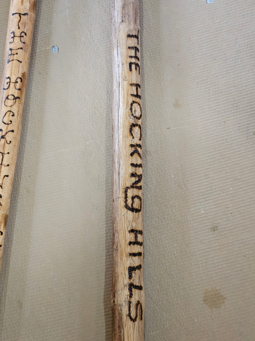 The Hocking Hills Store handmade wooden walking stick, natural wood with burned lettering.