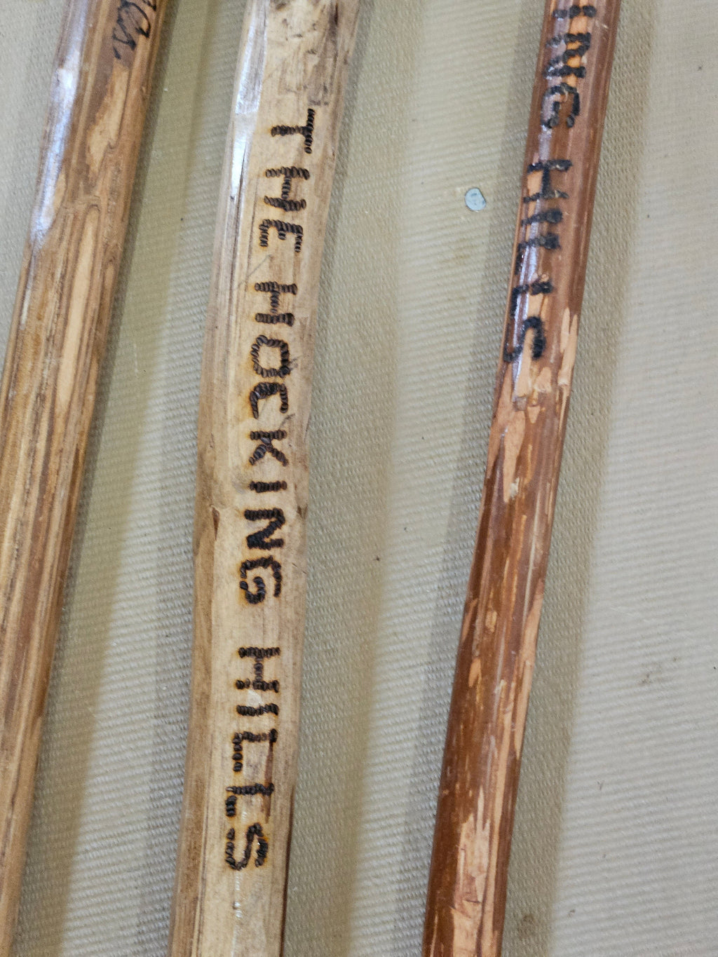 The Hocking Hills Store handmade wooden walking sticks, natural wood grain, one-of-a-kind artisan craftsmanship for hiking.