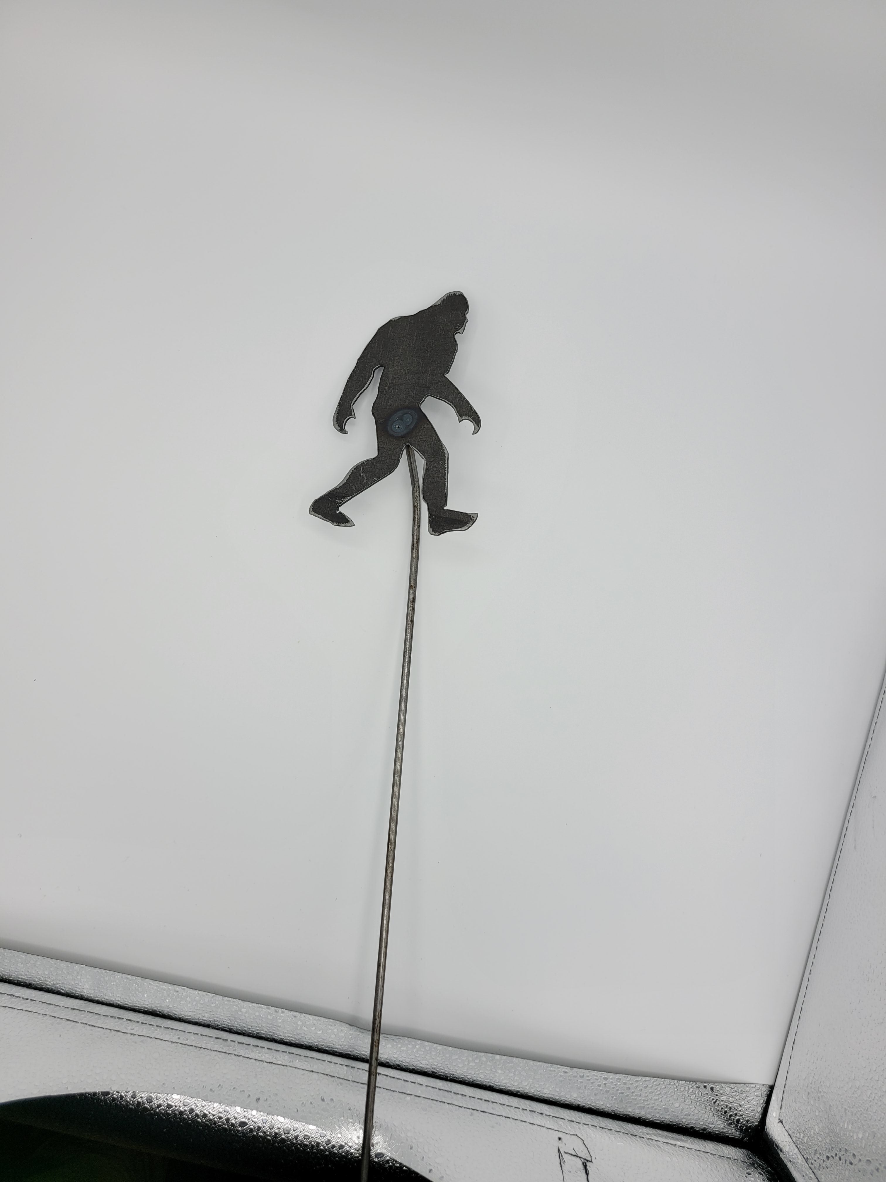 The Hocking Hills Store Bigfoot metal garden stake, dark grey silhouette on a thin metal rod.