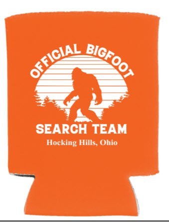 The Hocking Hills Store Official Bigfoot Search Team orange can cooler with Bigfoot silhouette and trees graphic.