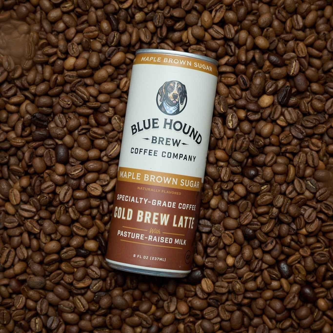 The Hocking Hills Store Maple Brown Sugar Cold Brew Latte can surrounded by coffee beans.