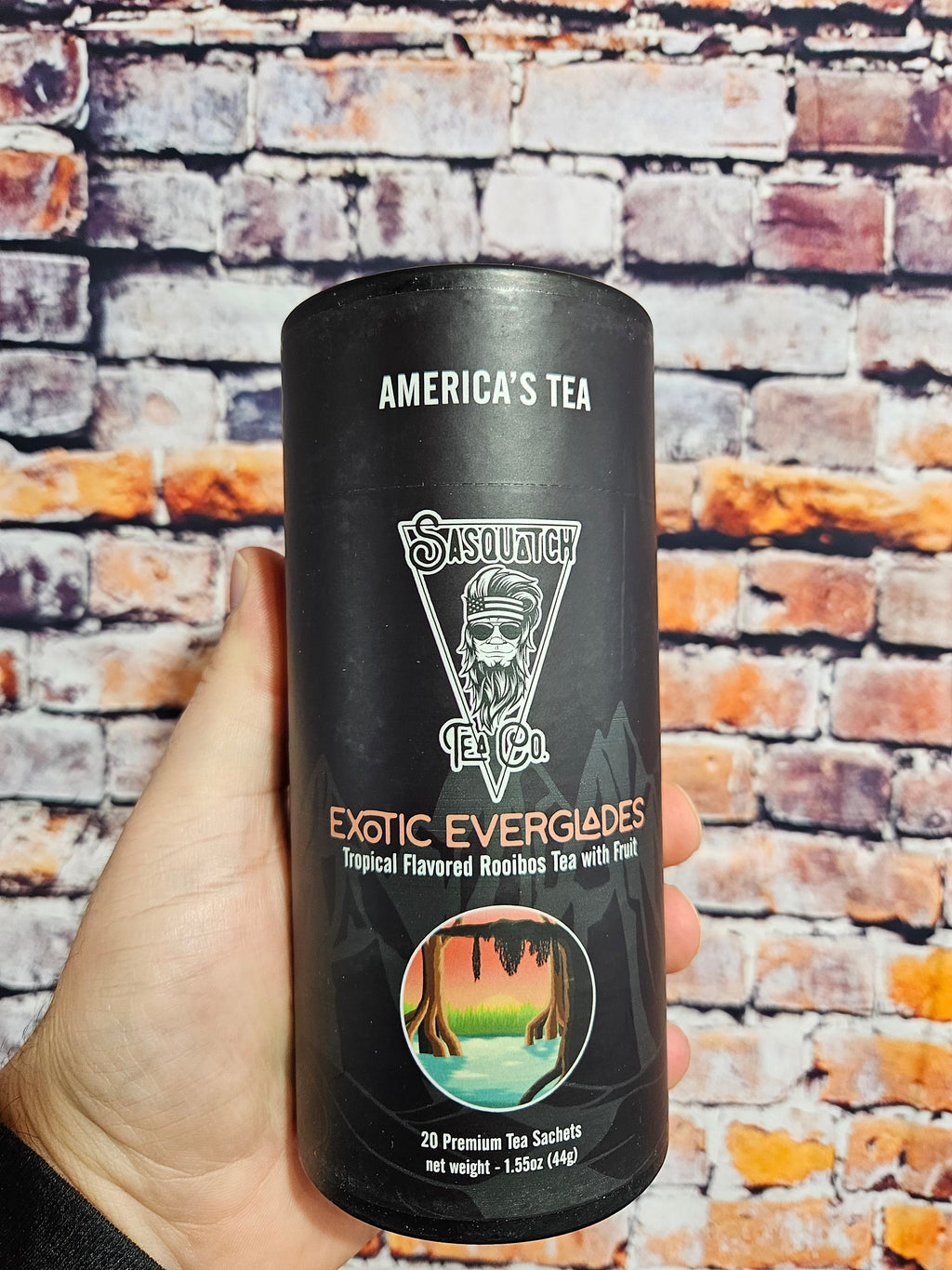 The Hocking Hills Store Sasquatch Tea Exotic Everglades tropical flavored rooibos tea in a black cylinder with 20 premium tea sachets.